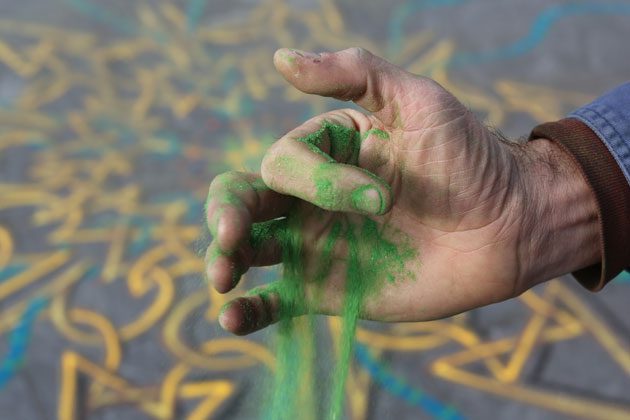 Man Uses a Bit of Sand To Transform Dirty Sidewalks Into Colorful Art