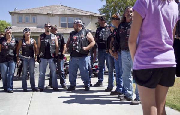 Group Of Bikers Surround A Child To Protect Her