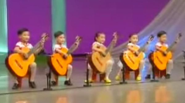 children perform with guitars