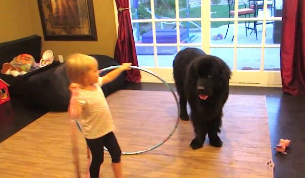 girl hula hoops with her dog
