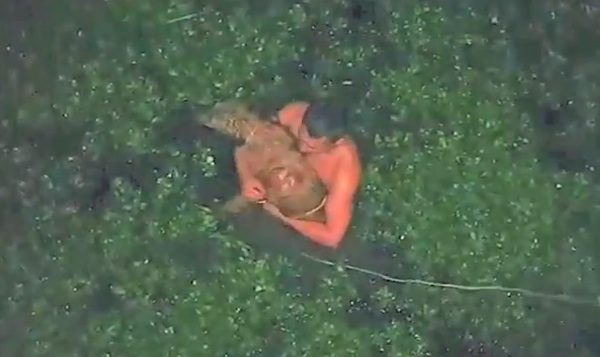Columbian policeman saves dog from wetland