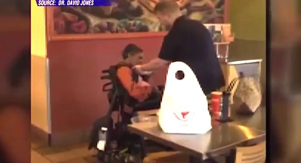 man helps disabled woman
