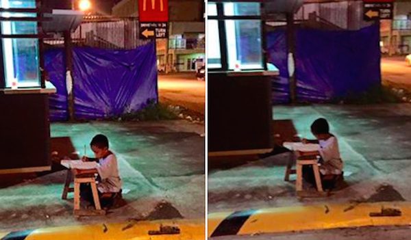homeless kid studies on street