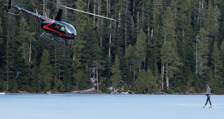 Figure Skater Performs On Beautiful Frozen Mountain Lake