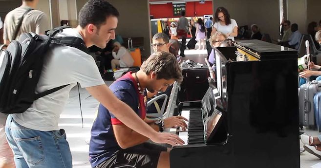 strangers play piano together