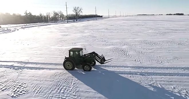 Farmer Makes Snowy Season’s Greeting Using A Tractor