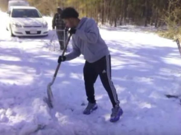 teen shovels snow for senior