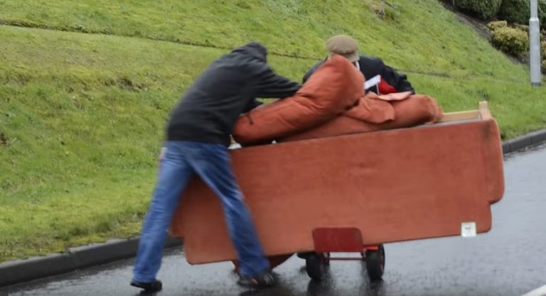 drunk men wheeling sofa