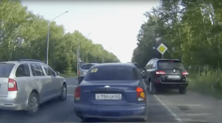 Impatient Driver Gets A Dose Of Instant Karma After Driving In Grass To Cut Through Traffic