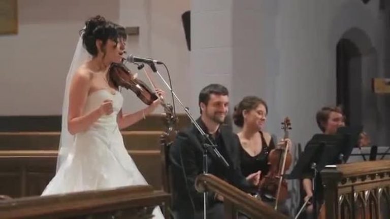 bride sings to groom at wedding ceremony