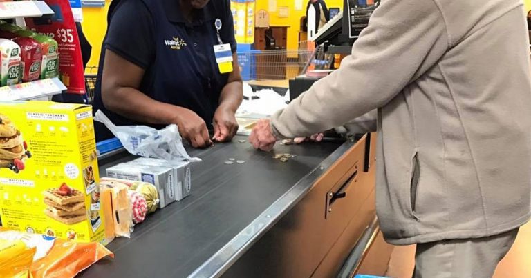 cashier helps senior count change