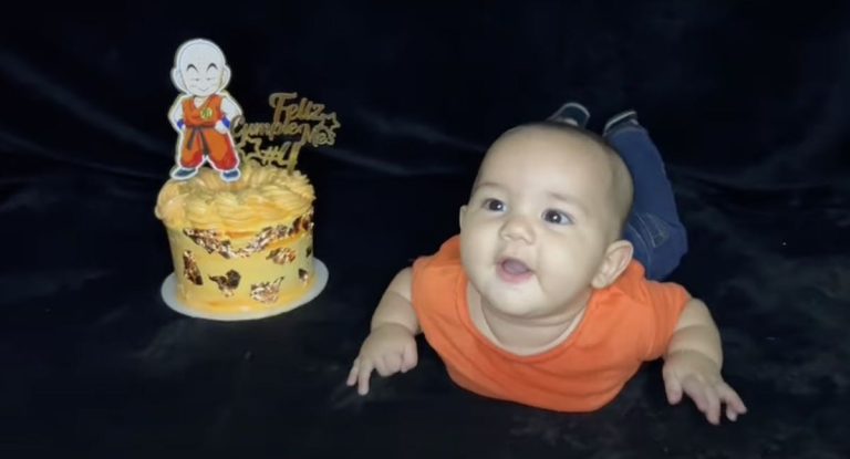 baby rolls into birthday cake