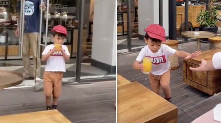 boy carrying drink has accident