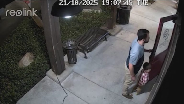 father and son stand guard outside unopened candy shop